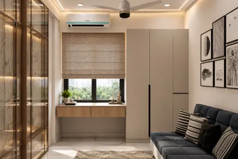 Reading room, window desk, Gulmohar House. An oak desk under a roman blind, a reeded-glass partition, and tall handle-less storage.